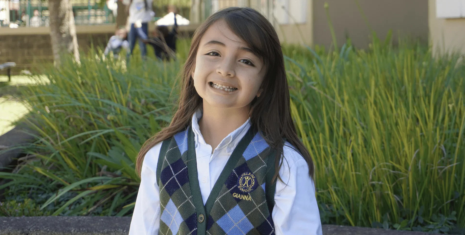Village School student smiling on campus